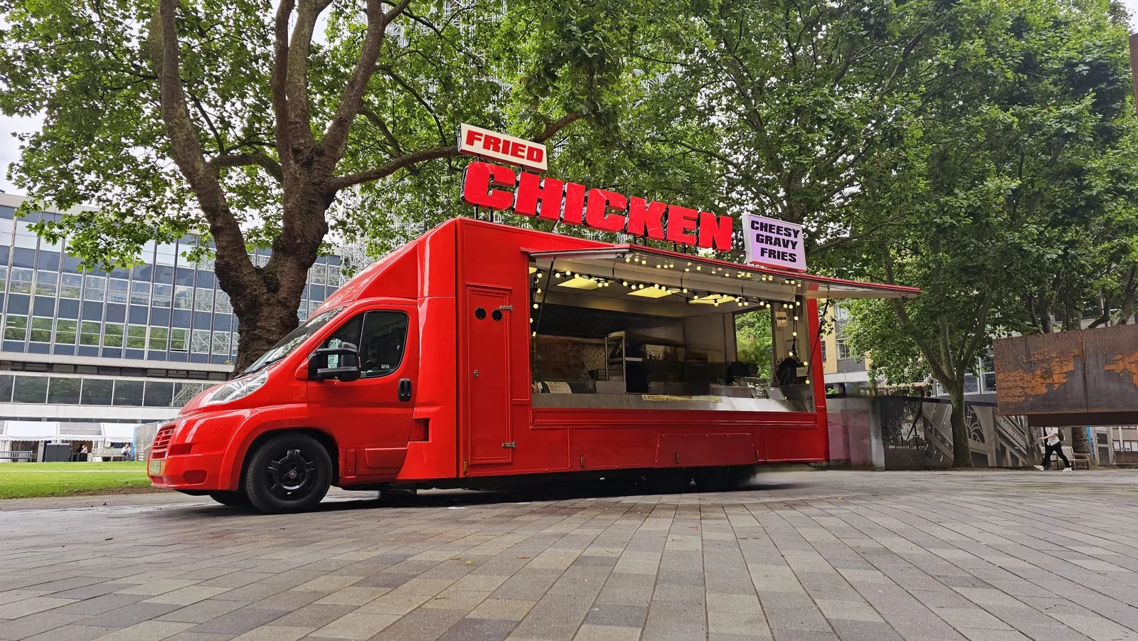 Big Red Japanese Chicken Shop food truck with its hatch open beneath trees